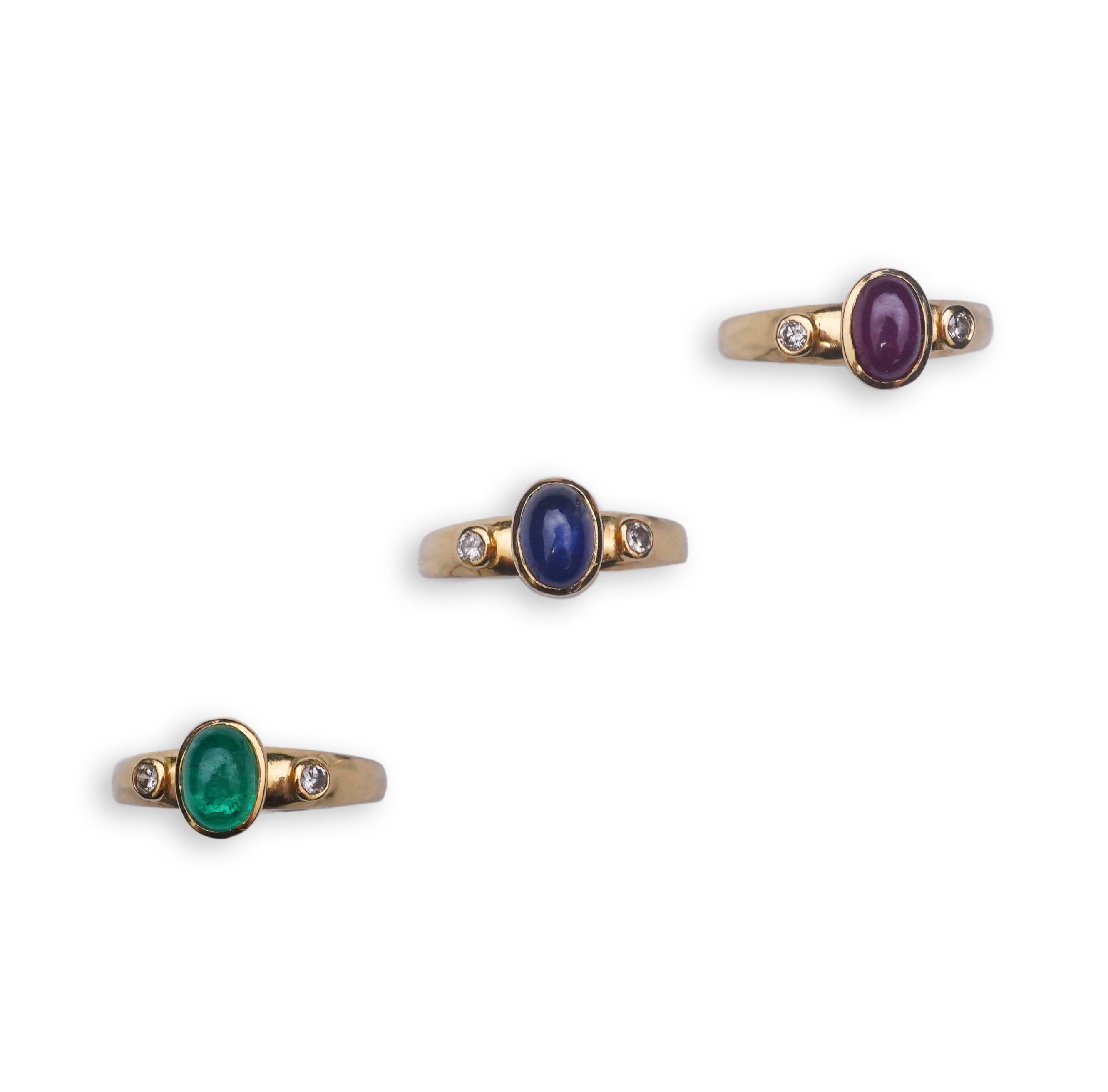 A suite of three gold and gem-set rings